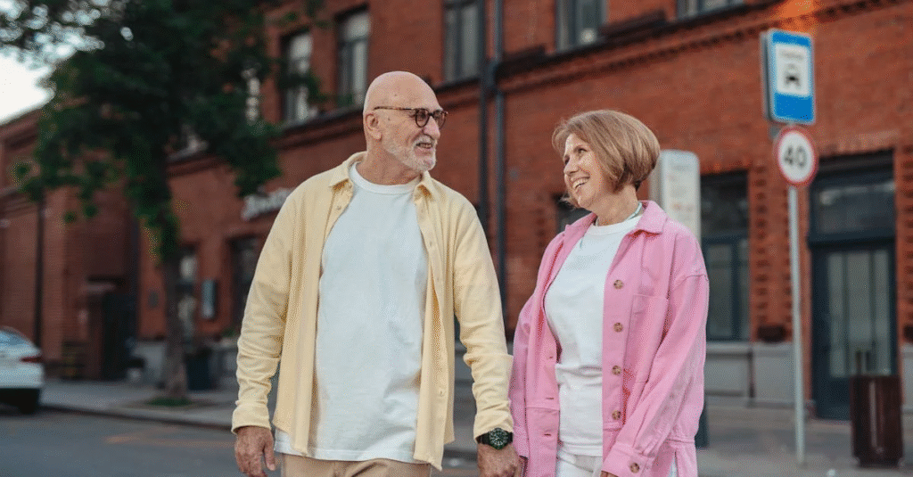 Smiling elderly couple holding hands, symbolizing security and planning for the future