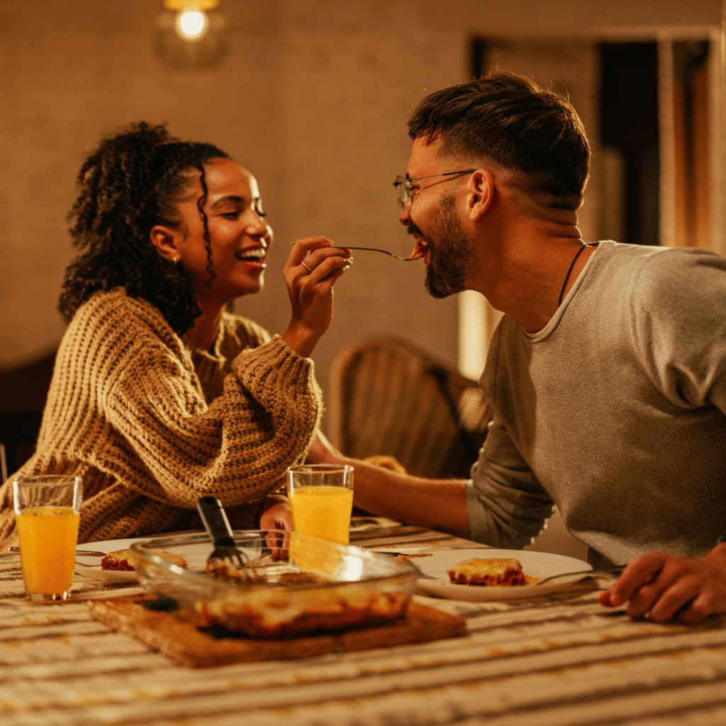 Happy couple enjoying a meal together, celebrating the rewards of financial growth.